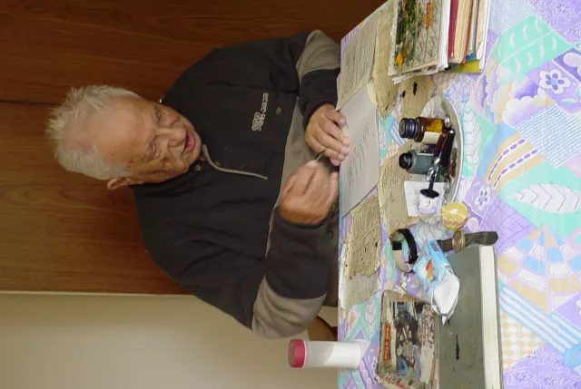 Avram Sadikario at work writing poetry